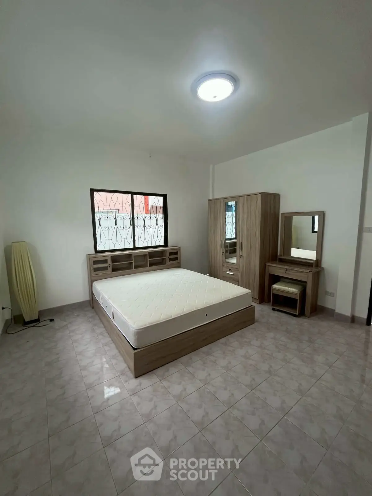 Spacious bedroom with modern furniture and natural light