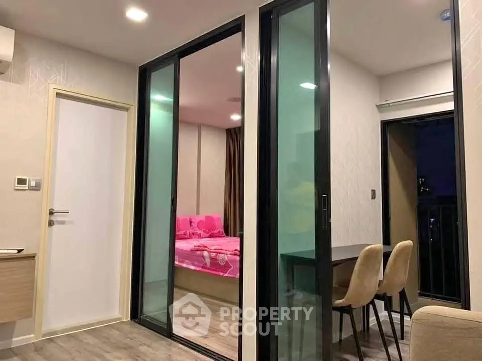 Modern apartment interior with sliding glass doors and cozy dining area