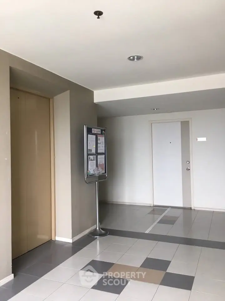 Modern apartment building corridor with elevator and notice board