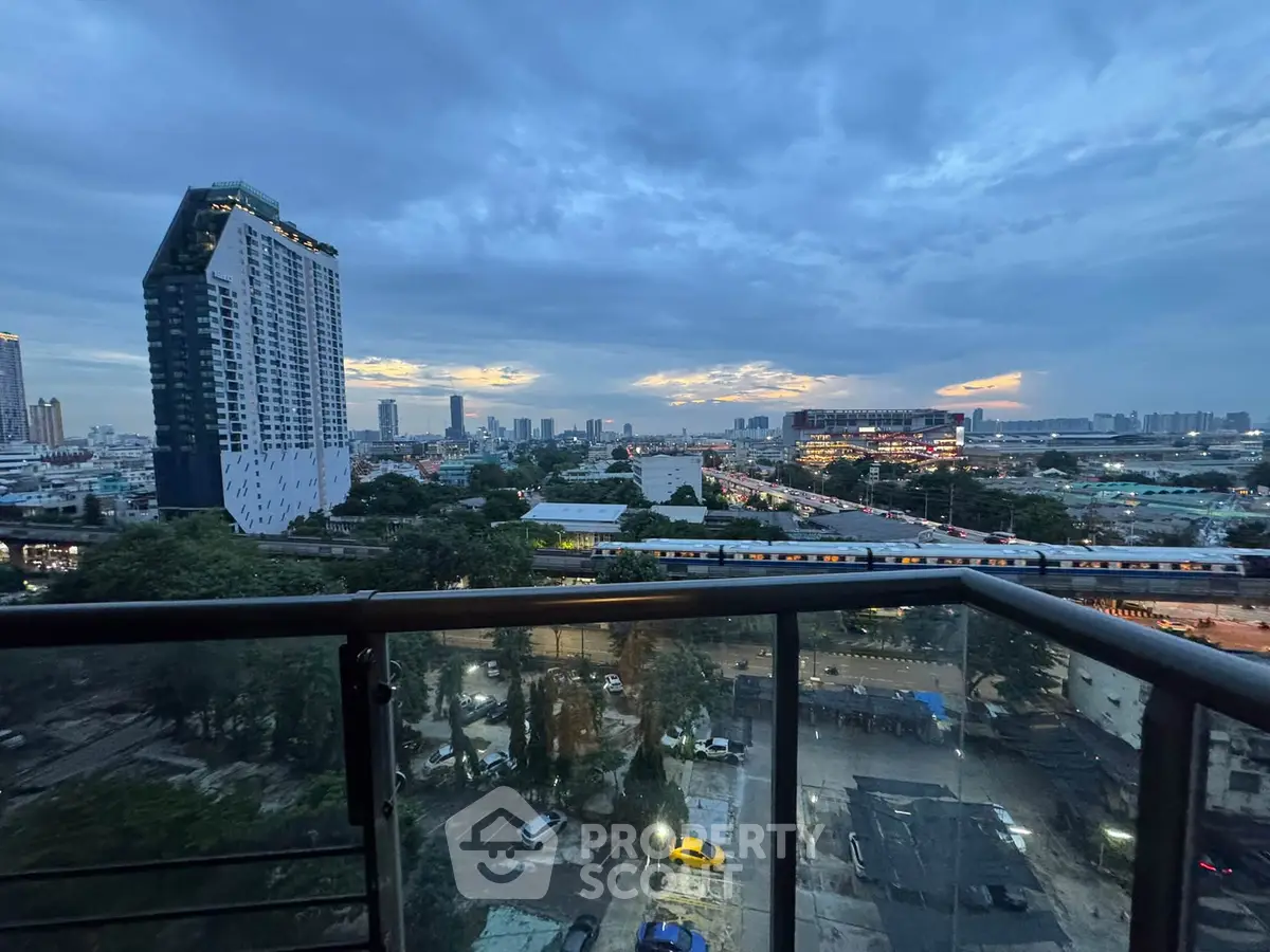 Stunning cityscape view from a high-rise balcony at dusk, showcasing urban skyline and vibrant city life.