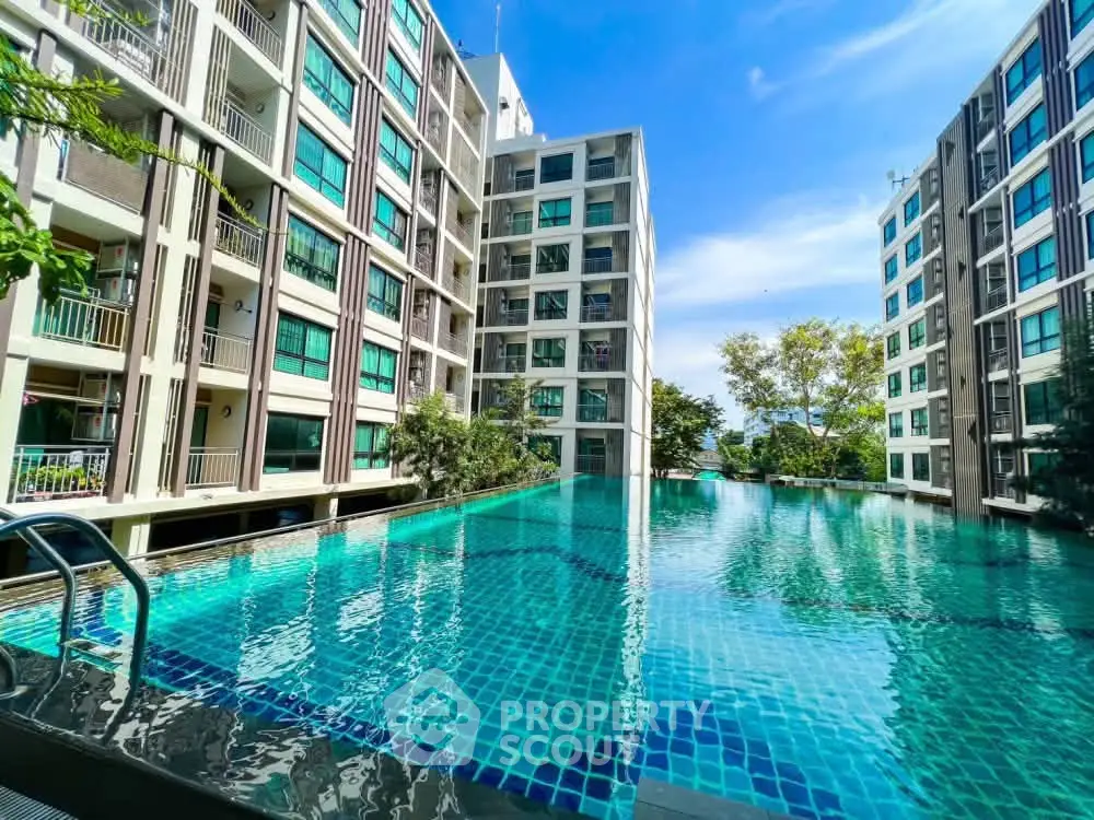 Luxurious condominium with stunning pool and modern architecture, perfect for urban living.