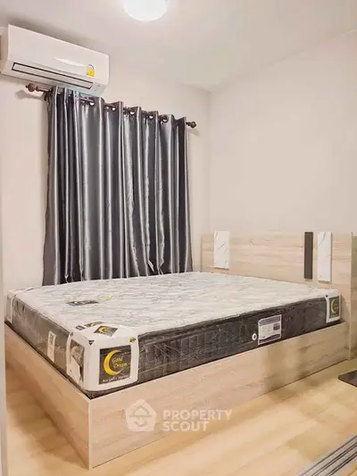 Modern bedroom with stylish bed and sleek air conditioning unit.