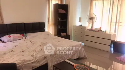 Spacious bedroom with modern furnishings and natural light