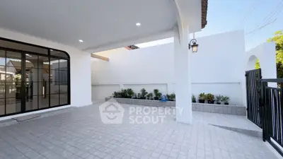 Spacious modern patio with elegant tiled flooring and stylish lighting, perfect for outdoor relaxation.