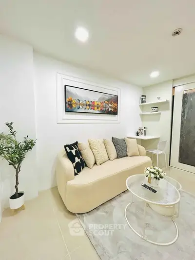 Modern living room with stylish sofa, chic decor, and elegant lighting in a cozy apartment.
