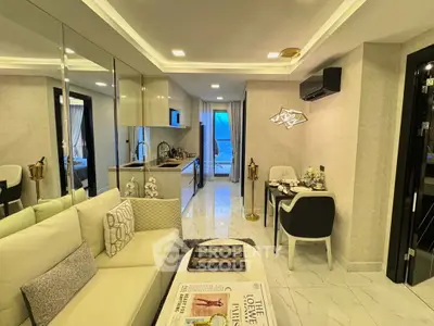 Modern living room with open kitchen, elegant decor, and stylish furniture.