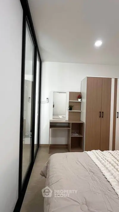 Modern bedroom with sleek wardrobe and cozy bed in minimalist design.