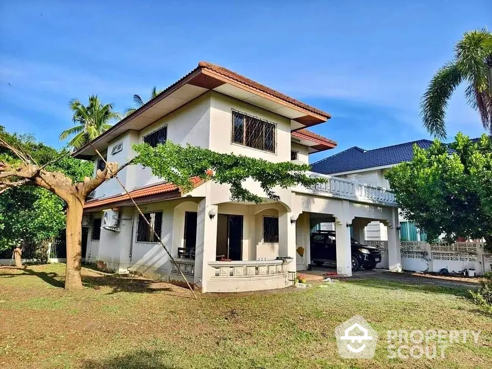 Charming two-story house with spacious garden and carport in tropical setting