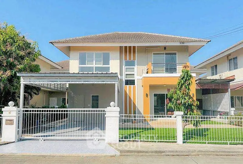 Modern two-story house with spacious driveway and lush green lawn