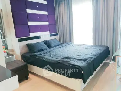 Modern bedroom with stylish purple accent wall and cozy bedding