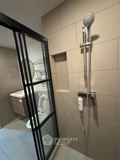 Modern bathroom with sleek shower and stylish fixtures in contemporary apartment.