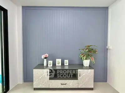 Modern living room with stylish console table and decorative plants