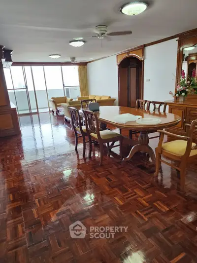 Spacious living room with elegant wooden flooring and dining area