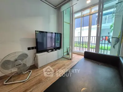Modern living room with sleek TV setup and balcony view