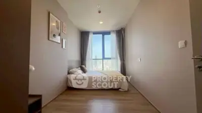 Spacious bedroom with city view and modern decor