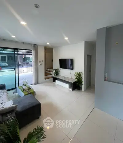 Modern living room with sleek design and large windows for natural light.
