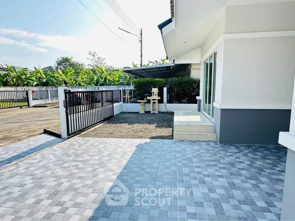 Spacious modern home exterior with tiled driveway and garden view