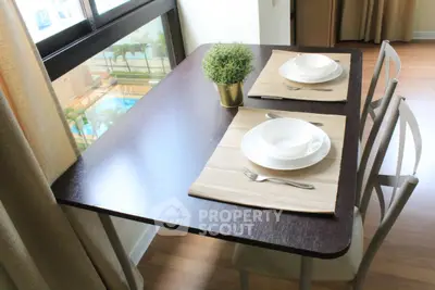 Chic dining area with pool view, featuring elegant table setting and natural light.