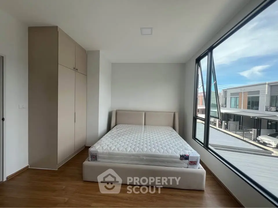 Spacious bedroom with large windows and modern design