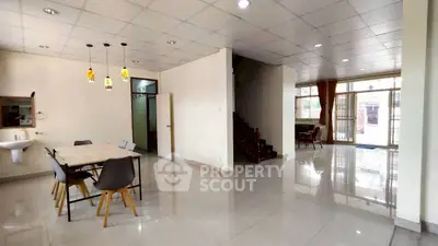 Spacious open-plan living area with dining space and staircase in modern home.