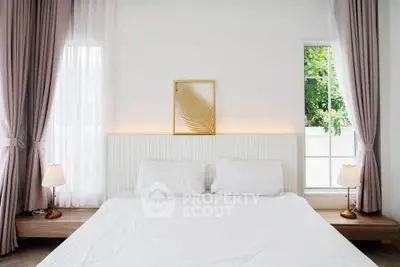 Elegant bedroom with large windows and stylish decor, featuring soft lighting and modern furnishings.