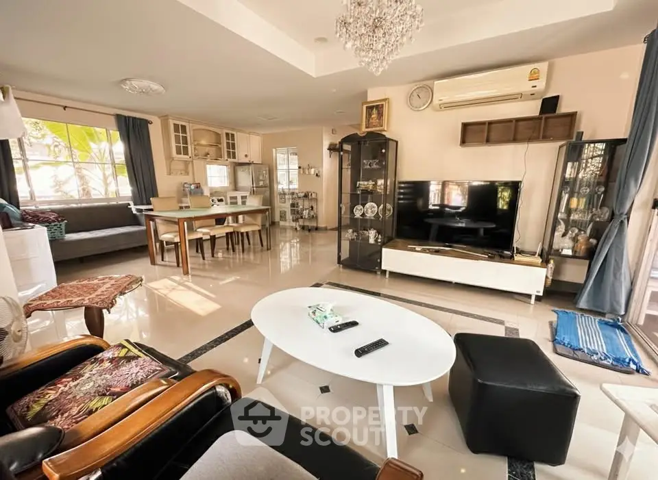 Spacious living room with modern decor and ample natural light.