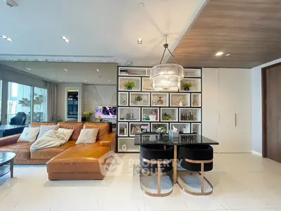 Luxurious modern living room with leather sofa and elegant dining area, featuring stylish shelving and chic lighting.