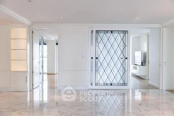 Luxurious modern living room with marble flooring and elegant glass doors