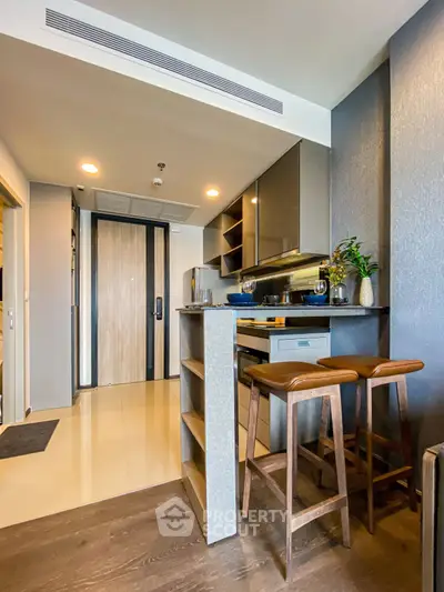 Modern kitchen with sleek design and bar seating in a stylish apartment