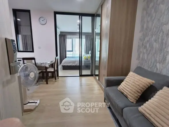 Modern apartment interior with cozy living area and bedroom view