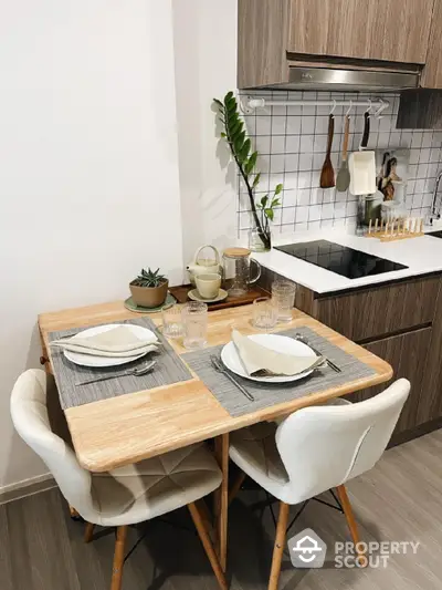 Cozy kitchen with modern wooden cabinets and compact dining setup