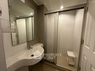 Modern bathroom with sleek shower and stylish sink in contemporary home.