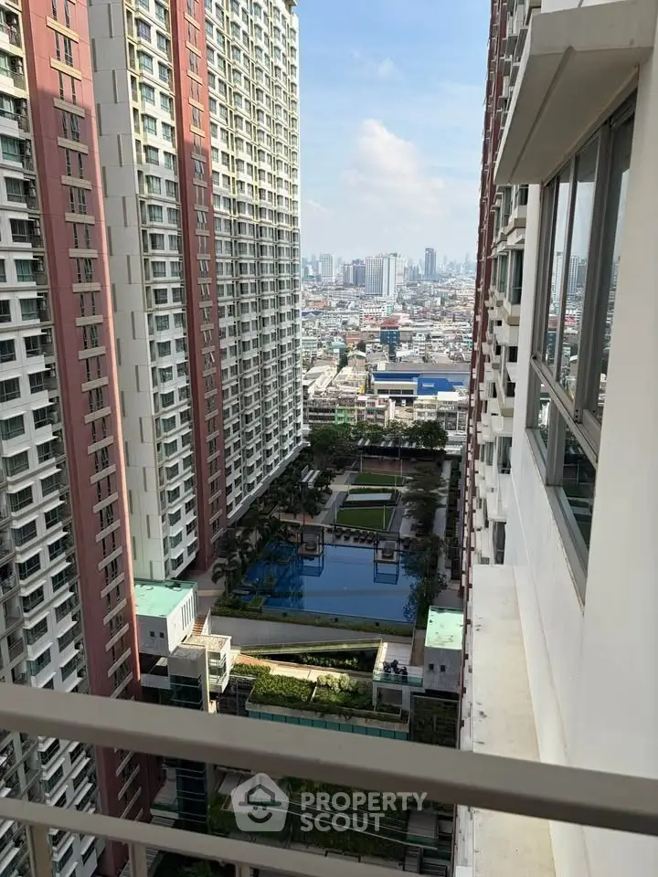 Stunning high-rise apartment view with pool and cityscape in the background.