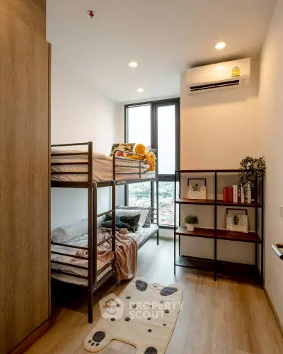 Modern bedroom with bunk beds and city view, ideal for urban living.