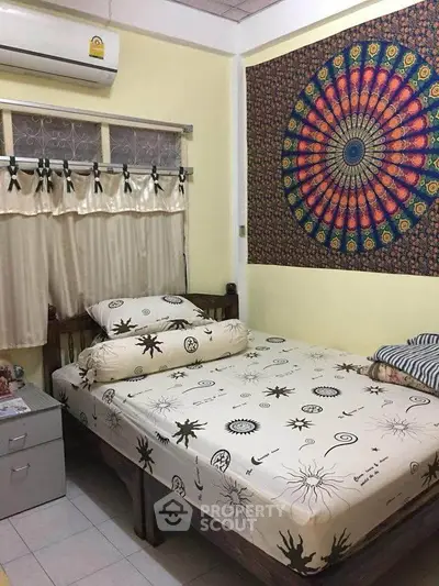 Cozy bedroom with artistic wall tapestry and air conditioning