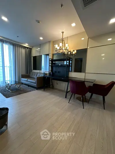 Modern living room with elegant chandelier and stylish furniture