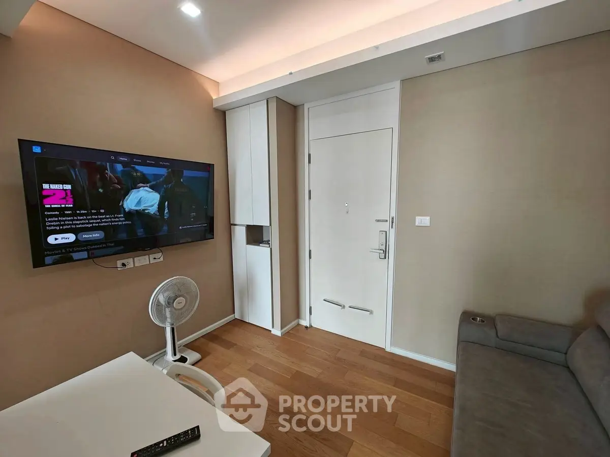Modern living room with wall-mounted TV and cozy sofa
