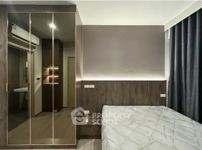 Modern bedroom with mirrored wardrobe and stylish lighting
