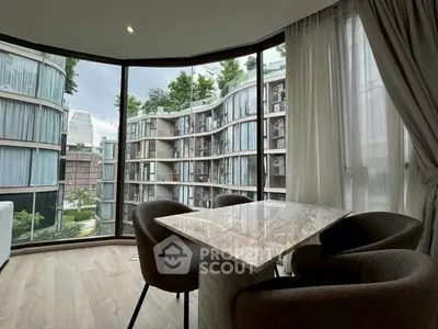 Modern apartment with floor-to-ceiling windows offering stunning views of contemporary architecture.