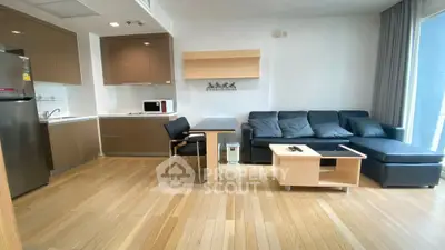 Modern living room with sleek furniture and open kitchen layout