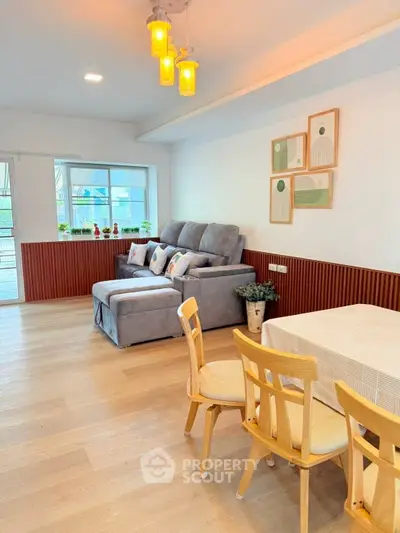 Charming living room with cozy sofa and dining area, perfect for relaxation and entertaining.