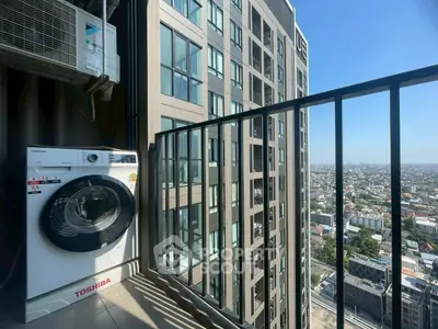 High-rise balcony with washing machine and city view