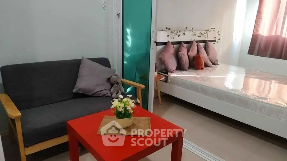 Cozy bedroom with modern decor and a small seating area, perfect for relaxation and comfort.