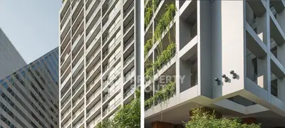 Modern architectural building with lush greenery and sleek design.