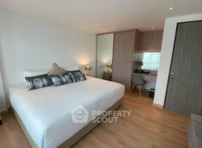 Modern bedroom with large bed and stylish decor in a contemporary apartment.
