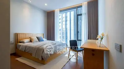 Modern bedroom with large window, wooden furniture, and elegant decor in a stylish apartment.