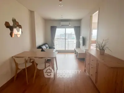 Spacious living room with modern furniture and city view, perfect for urban living.