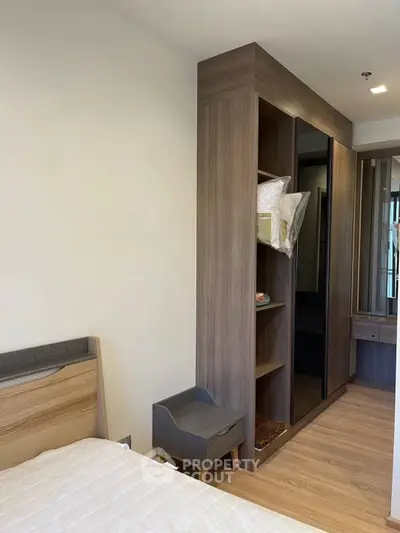 Modern bedroom with stylish wooden wardrobe and cozy bed setup