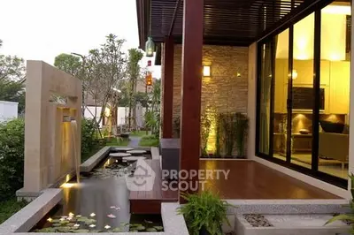 Stunning modern home exterior with elegant water feature and lush garden