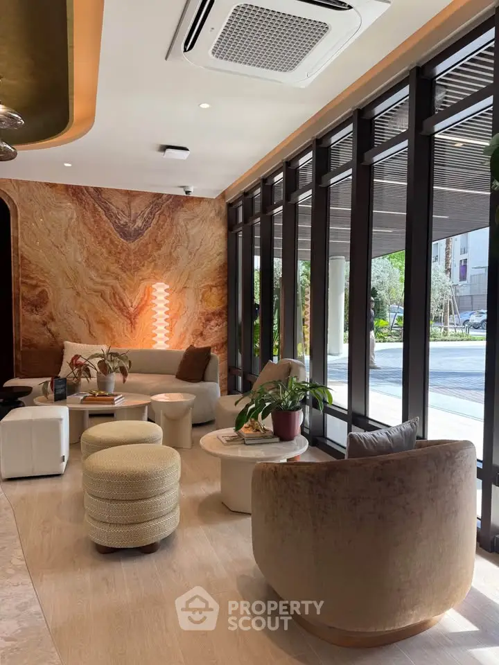 Luxurious modern living room with elegant furniture and large windows offering a stunning view.
